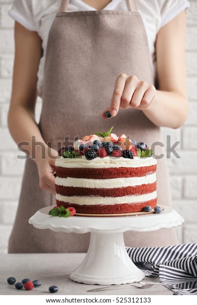 Woman decorating delicious\
cake