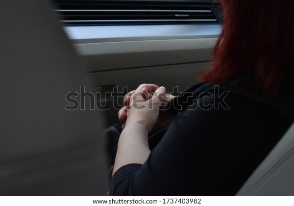 woman in deep thoughts in\
the car.