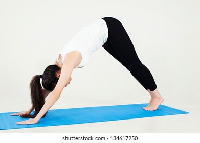 Woman Demonstrates Downward Facing Dog Yoga Pose