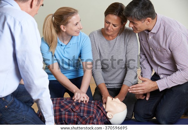 Woman Demonstrating Cpr On Training Dummy Stock Photo 370596695 ...