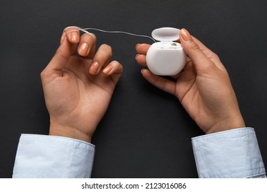 Woman With Dental Floss On Black Background