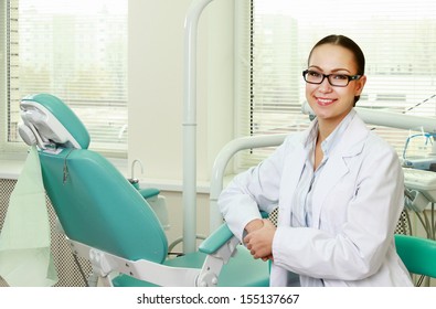 Woman Dentist At Her Office Smiling