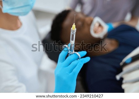 Woman dentist holding sterile syringe with anaesthetic to relief pain Сток-фото © 