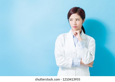 woman dentist serious look somewhere on the blue background