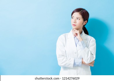 woman dentist serious look somewhere on the blue background