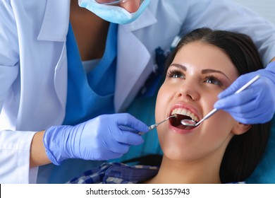 Woman Dentist Working At Her Patients Teeth