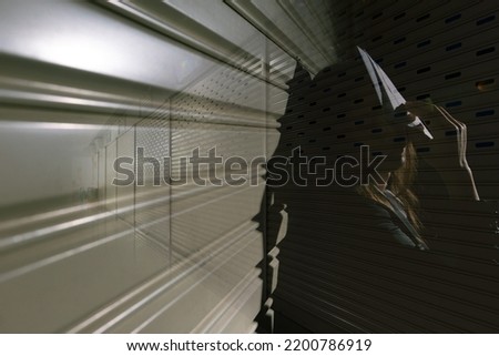 Woman depressed from sad stress pain despair problem, person sit on closed shop on corridor alone with emotion lonely desperate upset head down. Black Dark Underexposure concept, copy space