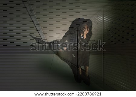 Woman depressed from sad stress pain despair problem, person sit on closed shop on corridor alone with emotion lonely desperate upset head down. Black Dark Underexposure concept, copy space