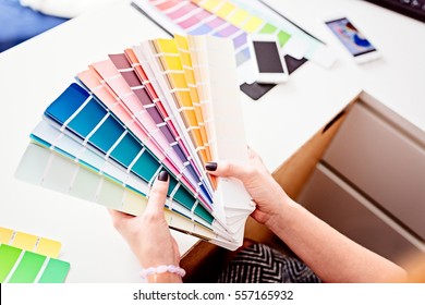 Woman designer or architect choosing color from color palette