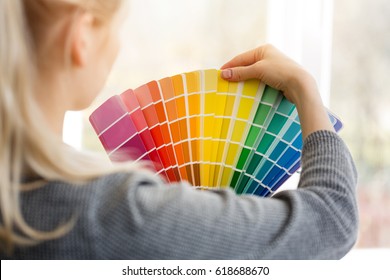 woman designer choosing interior design color from swatch palette
