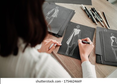 Woman designer drawing fashion sketches for her future collection - Powered by Shutterstock