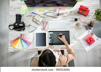 woman designer working on the pen table in office top view - Shutterstock ID 390553096