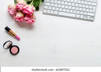 Woman desk with accessories and flowers on white background