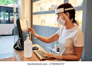 Woman At Desk Using Face Mask - Small Business Concept - Coronavirus Outbreak