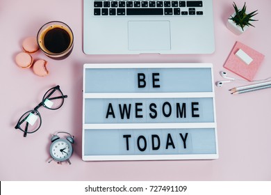 Woman Desktop Be Awesome Today  Laptop On Pink Coffee Glasses Pencils Plant Macaroons Alarm Clock Top View 