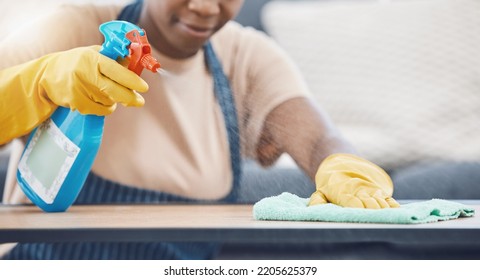 Woman With Detergent To Clean, Spray And Wipe Table, In Office Or Living Room In Home. Black Woman In Domestic Work, Use Cloth And Liquid Cleaner, On Desk For Hygiene In Lounge Of Business Or House