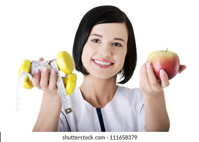 Woman Dietician Holding Apple And Dumbbells With Measuring Tape