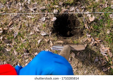 The Woman Digging A Hole With A Shovel In The Ground. Close Up Shot.