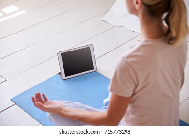 Woman With Digital Tablet Using Meditation App In Bedroom