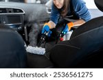 A woman diligently cleans the car