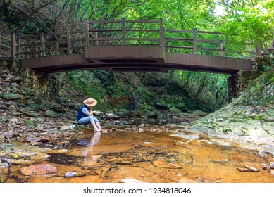 A Woman Dipping Her Feet In Cool Water At Surak Valley