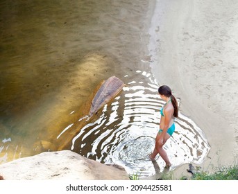 Woman Dipping Toe In Pool