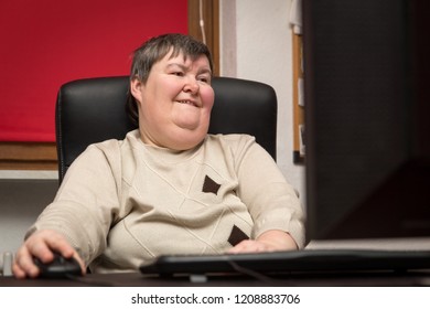 Woman With A Disability Develop Sitting At The Computer, Alternative Therapy And Workout