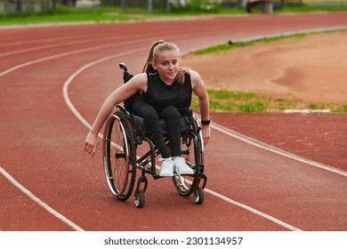 A woman with disablity driving a wheelchair on a track while preparing for future competitions. - Powered by Shutterstock