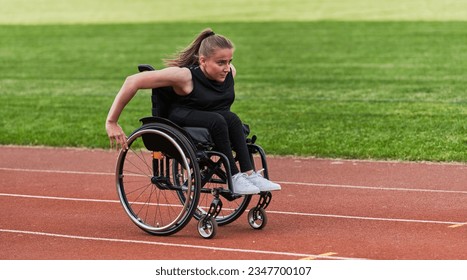 A woman with disablity driving a wheelchair on a track while preparing for the Paralympic Games - Powered by Shutterstock