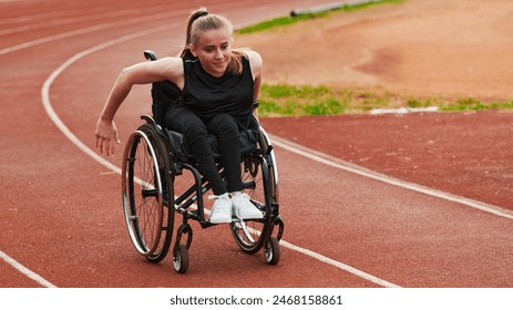 A woman with disablity driving a wheelchair on a track while preparing for the Paralympic Games - Powered by Shutterstock