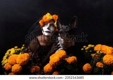 woman disguised as a catrina accompanied by her dog with cempazuchil flowers and a black background