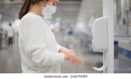 Woman Disinfecting Her Hands With Alcohol Gel On In Department Store, COVID-19, New Normal Retail Shop.