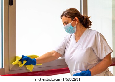 woman disinfecting hospital with mask and protection against coronavirus COVID-19 - Shutterstock ID 1758082961