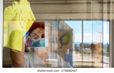 Woman Disinfecting Hospital With Mask And Protection Against Coronavirus COVID-19