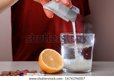 Woman dissolves medicine with soluble sachet in water. Soluble powder drug dissolved in water. headache, toothache