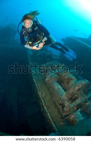 Woman diver exploring a wreck (Thistlegorm Red Sea)