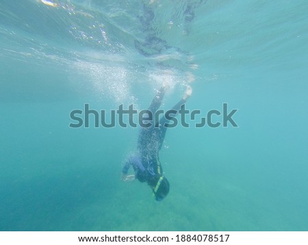 Woman diver snorkeling in Great Barrier Reef, Australia