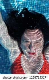 Woman Dives Underwater And Water Surface. Beautiful Abstract Blurred Red, Blue, Black And White Background. Water, Immune System And Woman Over 45.