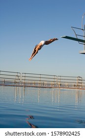 A Woman Diving Into A Pool