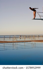 A Woman Diving Into A Pool