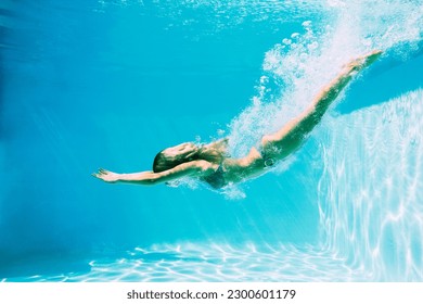 Woman diving into swimming pool - Powered by Shutterstock