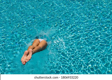 Woman Diving  At Luxury Five Stars  Spa Resort In The Swimming Pool In Greece