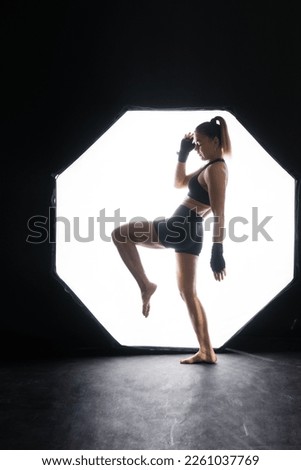 Similar – Rear view portrait of one young middle age athletic woman at crossfit training, exercising with trx suspension fitness straps over dark background