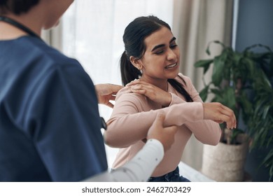Woman, doctor and appointment with shoulder pain, medical and patient conversation for health care concern. Clinic, muscle tension and talking with medic employee, injury and professional help - Powered by Shutterstock