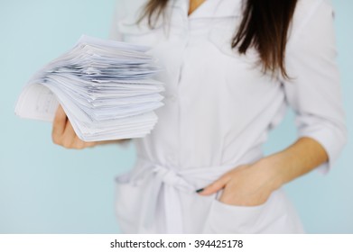 woman doctor with a bundle of sheets. - Shutterstock ID 394425178
