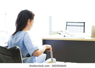 Woman Doctor Check The Pressure Of Women Patient's.The Female Doctor Smiled And Made Eye Contact With The Patient. Doctor Using Sphygmomanometer With Stethoscope Checking Blood Pressure To A Patient