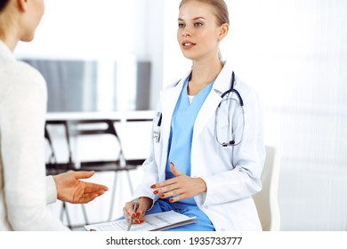 Woman - doctor consults her female patient in clinic. Medicine concept