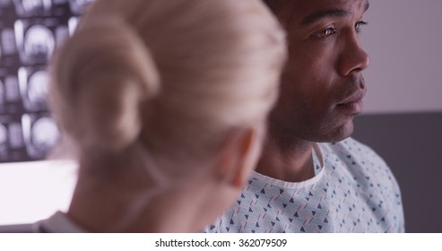 Woman Doctor Delivering Bad News To Black Patient