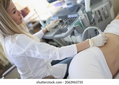 Woman Doctor Doing Kidney Ultrasound Examination In Clinic