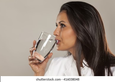 Woman Doctor Drinking A Water From A Glass